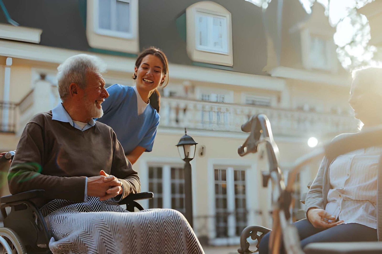 Nurse helping man in wheelchair - Care Transit Solutions