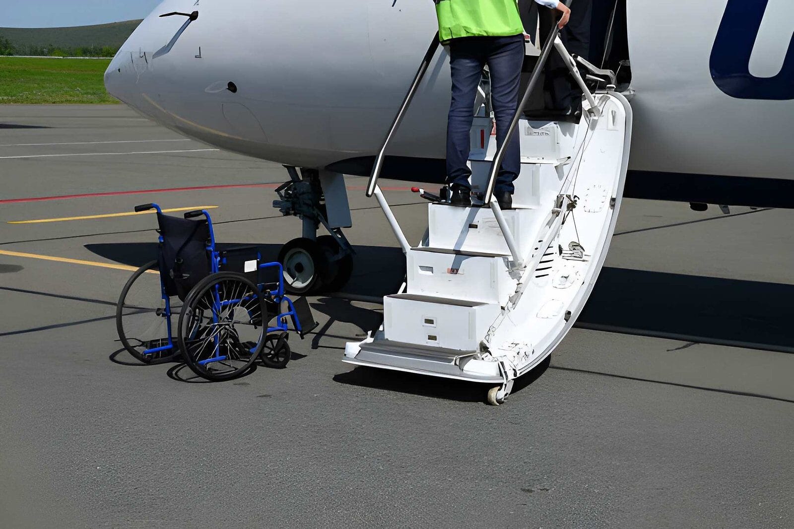 Wheelchair next to plane stairs - Care Transit Solutions