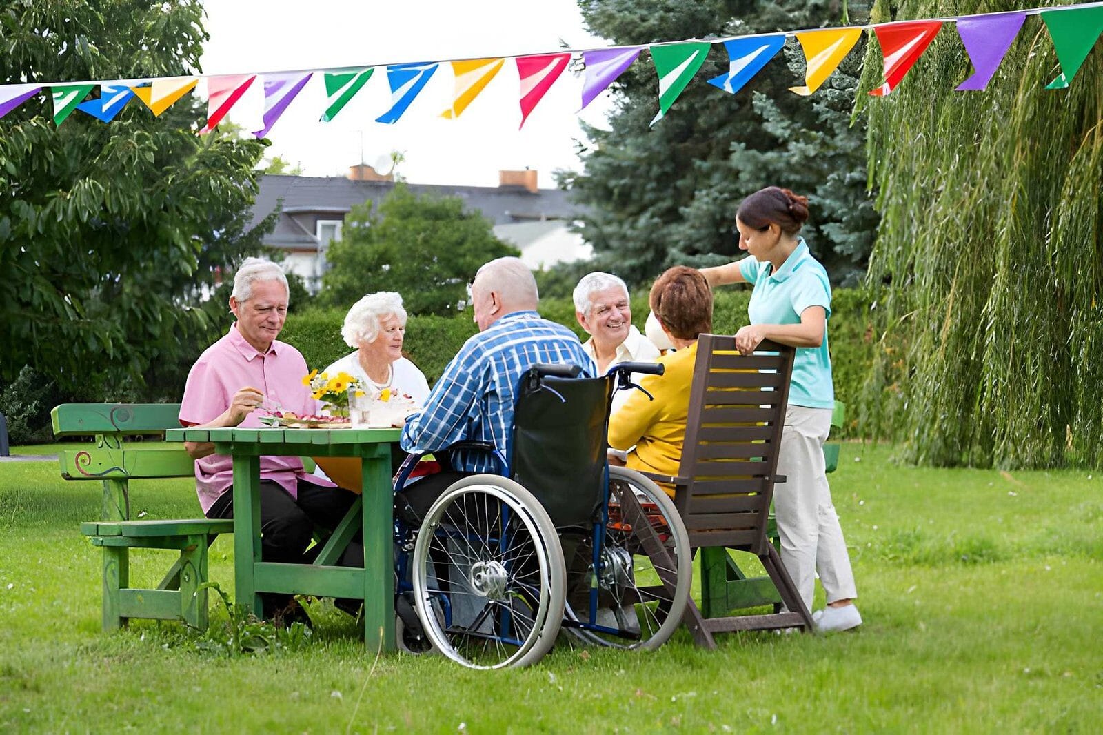 Seniors dining at garden party - Care Transit Solutions