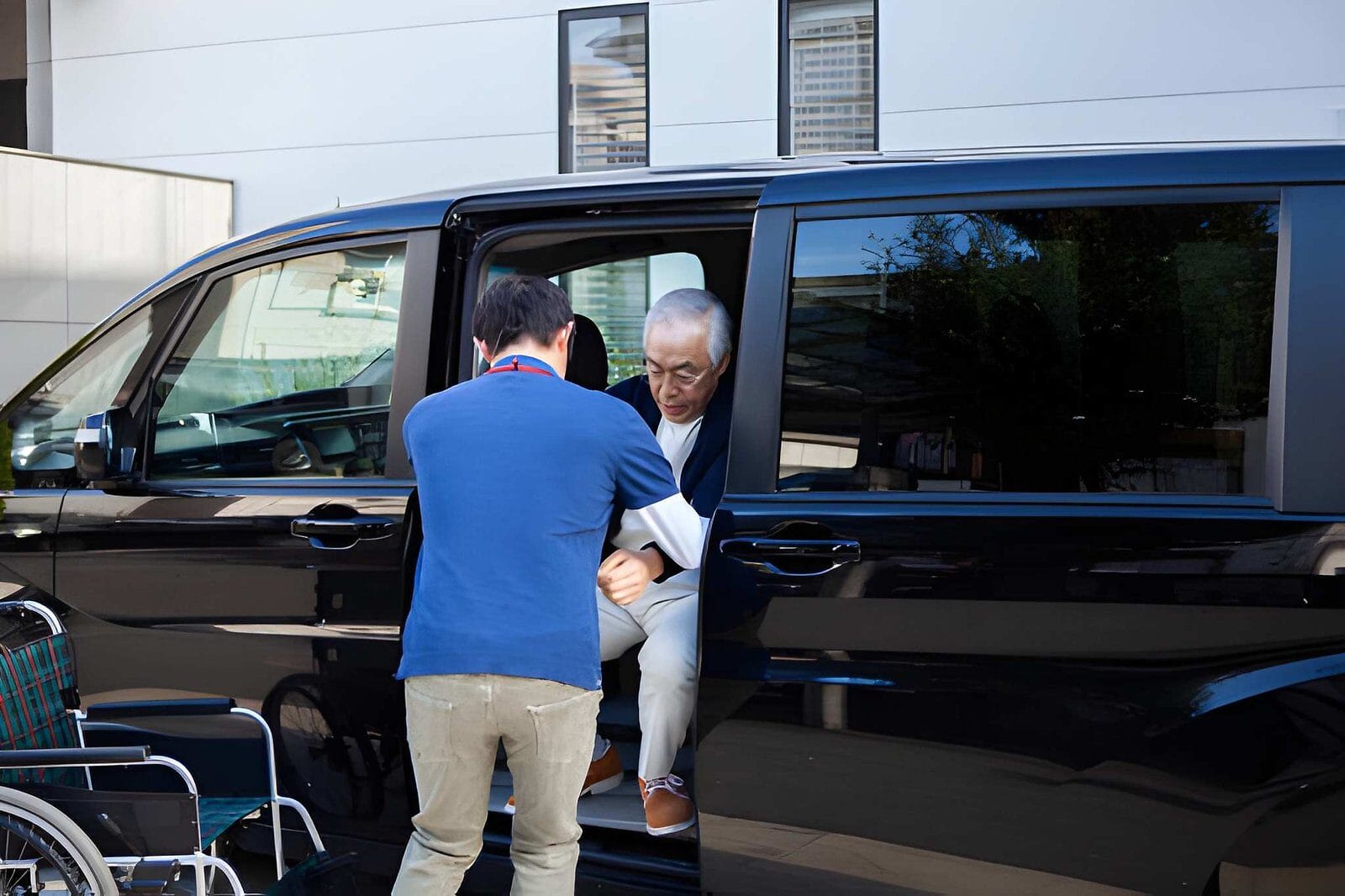 Man helping a senior from a van - Care Transit Solutions